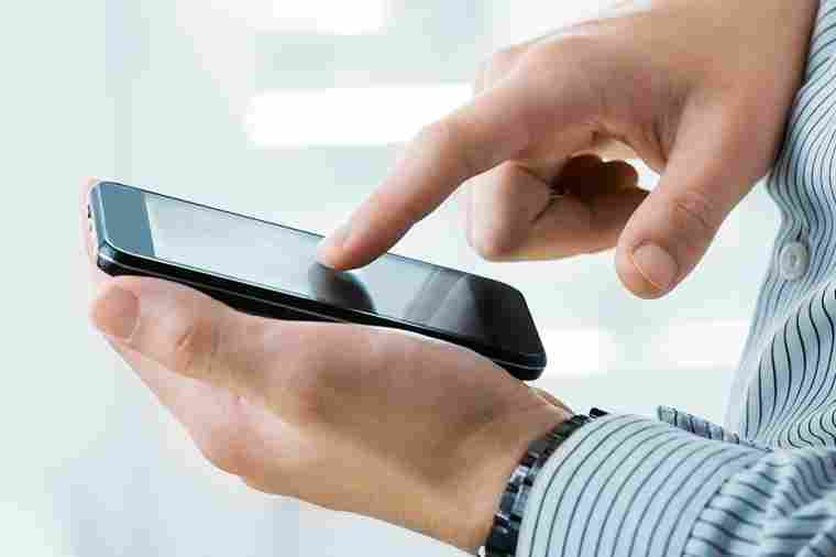 Person tippt auf Mobiltelefon