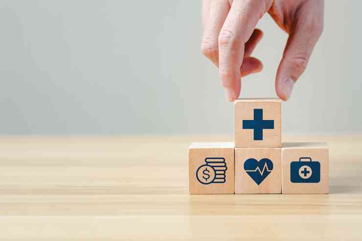 Hand legt einen Holzblock auf andere Blöcke